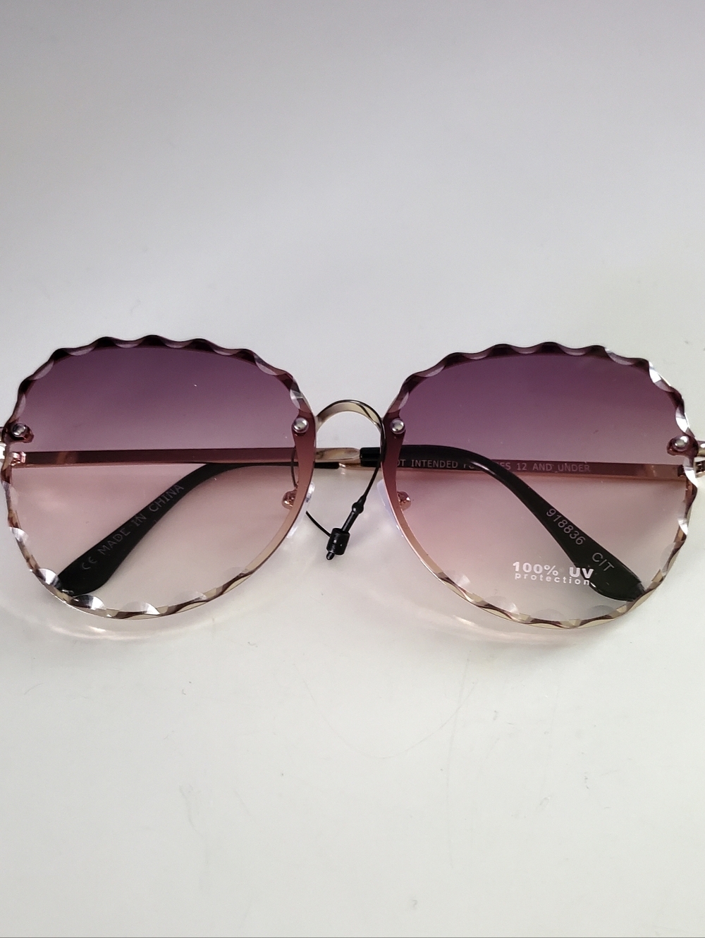 Rimless Round Sunglasses With A Scalloped Lens Design
